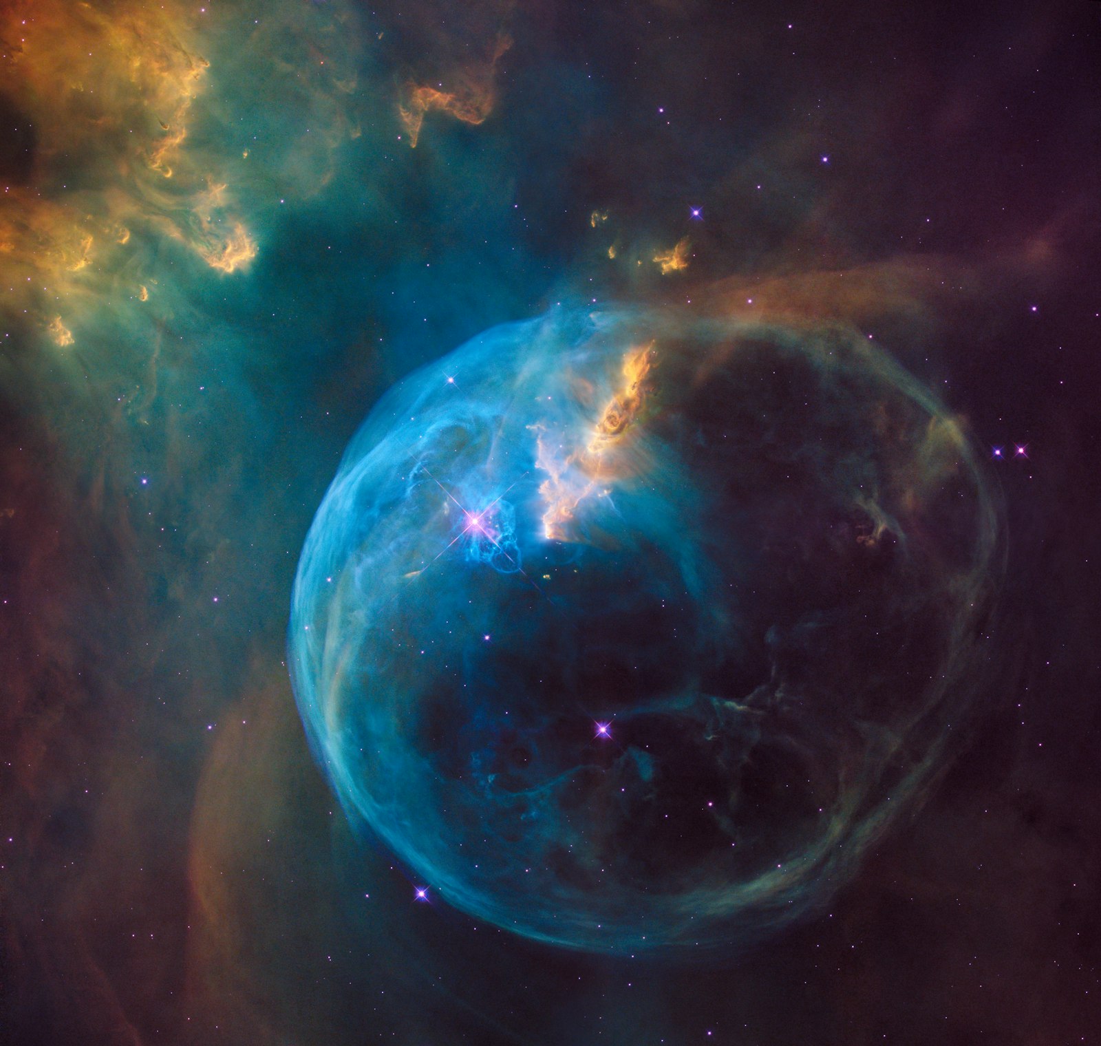 The Bubble Nebula glowing blue and gold in deep space
